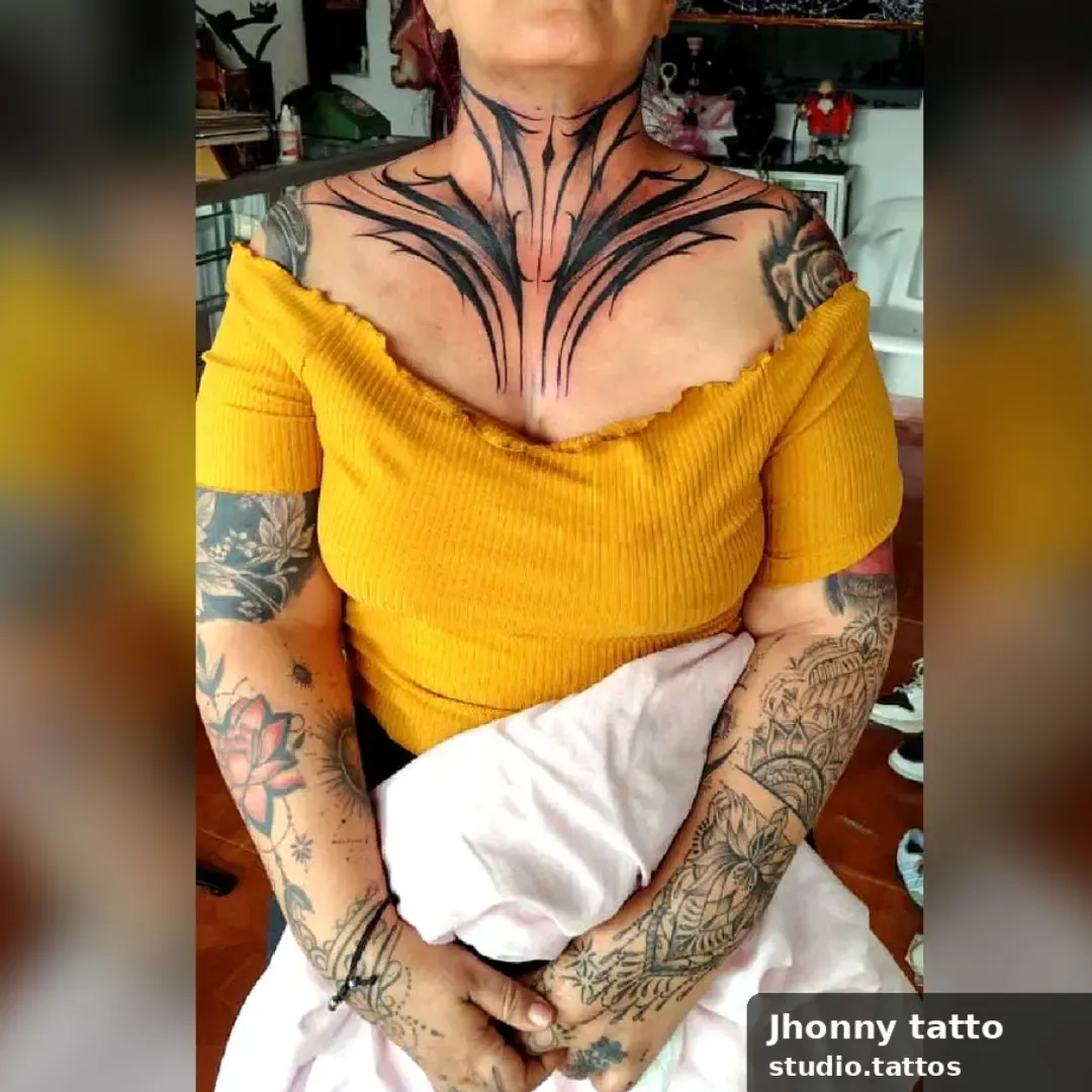 Pieza neotribal en cuello y pecho, negro sólido en puntas que siguen la clavícula